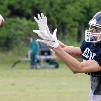 Kobe Null looks the ball into his hands during skilled position drills