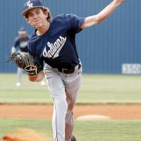 Coy Atkins squints as he throws a split-finger fastball