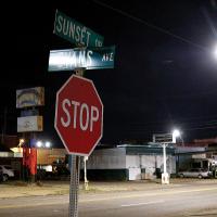 A night shot of Sunset Drive at the corner of Evans Avenue looking east
