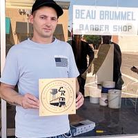 Sam Griesel IV poses with his Citation of Merit plaque