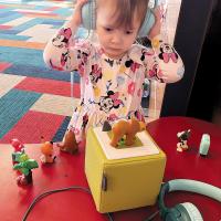 Evelyn Mace listening to Eric Carle’s Brown Bear, Brown Bear