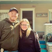 Brandon Payton gives Sue Bear a hug after presenting her with a $1,000 donation from the local Fraternal Order of Police