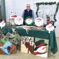Marie Hirst shows off her colorful paintings