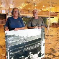 Janice and Mike Freeman hold up a photo of the JCPenney's building