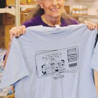 Nikki Pruitt shows off a Letter Carriers Food Drive T-shirt from last year