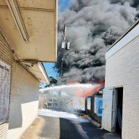 Thick, black smoke poured into the sky after a pile of tires caught fire
