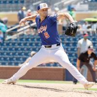 Cameron Hill strides into a pitch during