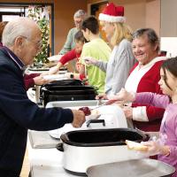 Lloyd Garrett gets a generous serving of food from Jensen Shepherd