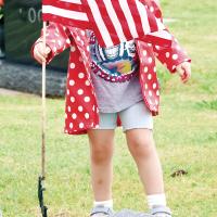 Colette Burns puts a flag on the grave of a veteran