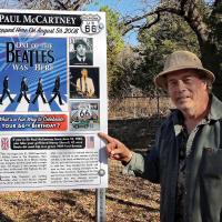 Toby Thompson points to the sign