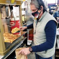 Tom Ross fills a bag with the gooey corn 