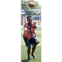 Toni Thompson runs under the football while attempting to make a catch.