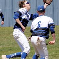 Tyler Norton steps in front of teammate Tyler Ross (6) to snag a fly ball