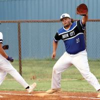 Aiden Ellington peeks at a base runner as a pickoff throw heads toward his glove