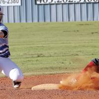 Jake Faerber has a pickoff throw bounce under his glove as a Vanoss runner slides into the bag