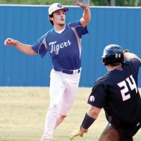 Blake Bailey leans over the bag to snag a relay throw as a OCA base runner slides into second