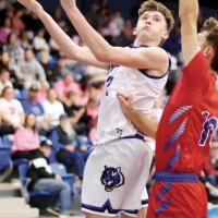 Carson Quigley leans into a Binger-Oney defender to get off a shot