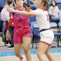Kamryn Cook makes a pass along the baseline over the arm of a Binger-Oney defender
