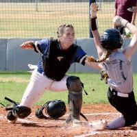 Makenna DeLong reaches out to tag a runner at the plate