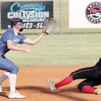 Morgan Brothers eyes a pickoff throw as a runner slides into second base
