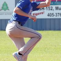 Tyler Norton reaches up to grab a high throw from the catcher