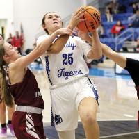 Kamryn Cook tries to power up a shot between two Vici defenders