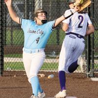 Kinley Jones reaches out to snag a throw to the bag