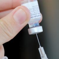 A syringe being filled with the COVID-19 Pfizer vaccine