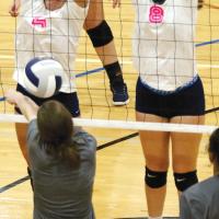 Jennis Goucher (4) and Cassie Avendano attempt a block