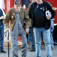 Raymond Stover walks into the Centre Theatre with the help of Ronnie Funck