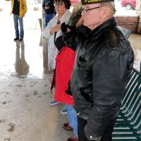 Robbie Clark and other veterans stand and salute