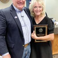 Steve Jensen recognizing the years of service from Vicki Proctor