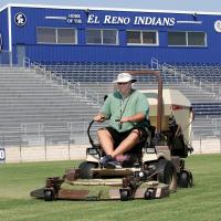 EHS head football coach Chuck Atchison cuts the grass at Memorial Stadium