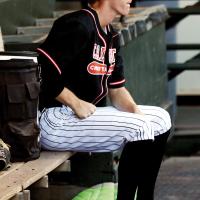 Kyler Thiessen sits quietly in the dugout