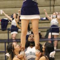 Briana Stevenson gets a boost into the air from teammates