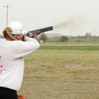 The load of buckshot can be seen flying past the smoke from the shotgun of Kenna Stamm