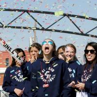 Ashlyn Evans-Thompson tries to catch pieces of confetti