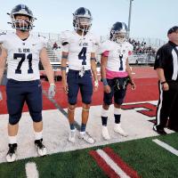 EHS captains wait to be called out to midfield for the pregame coin toss