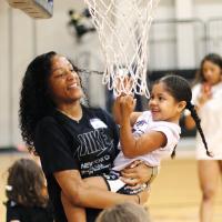 Janae Black-Harmon, left, gives Kennedi Elledge a boost