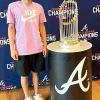 Vincent Walker stands next to the Commissioner’s Trophy