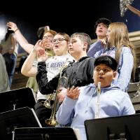Members of El Reno High School’s Jazz Band do a chant while watching to see if a shot falls