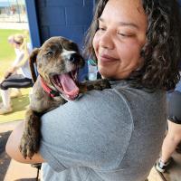 Summer Blackowl holds up her puppy, Buddy