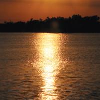 The sun shone bright over a bank of clouds overlooking Lake El Reno