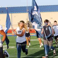 Shayne Castrop and Dillon Hamlett carry the EHS flags onto the field