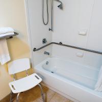 A shower bench and grab bars in the bathroom makes bathing easier