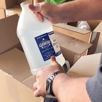 A worker checks a bottle of hand sanitizer
