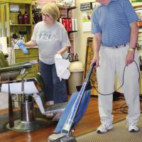 Joe Howarton vacuums the floor at Royal Razor