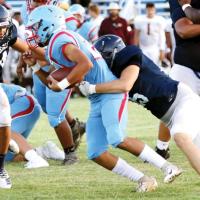 Mikey Devereaux (34) closes in to help Brody Robinson tackle a Lawton Eisenhower ball carrier.