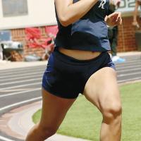 Aneesa Woods runs out of the curve in the 200-meter dash