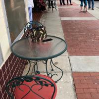A table and chairs on the sidewalk outside the Centre Theatre